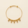 PULSERA RIGIDA CON PELOTITAS COLGANTES